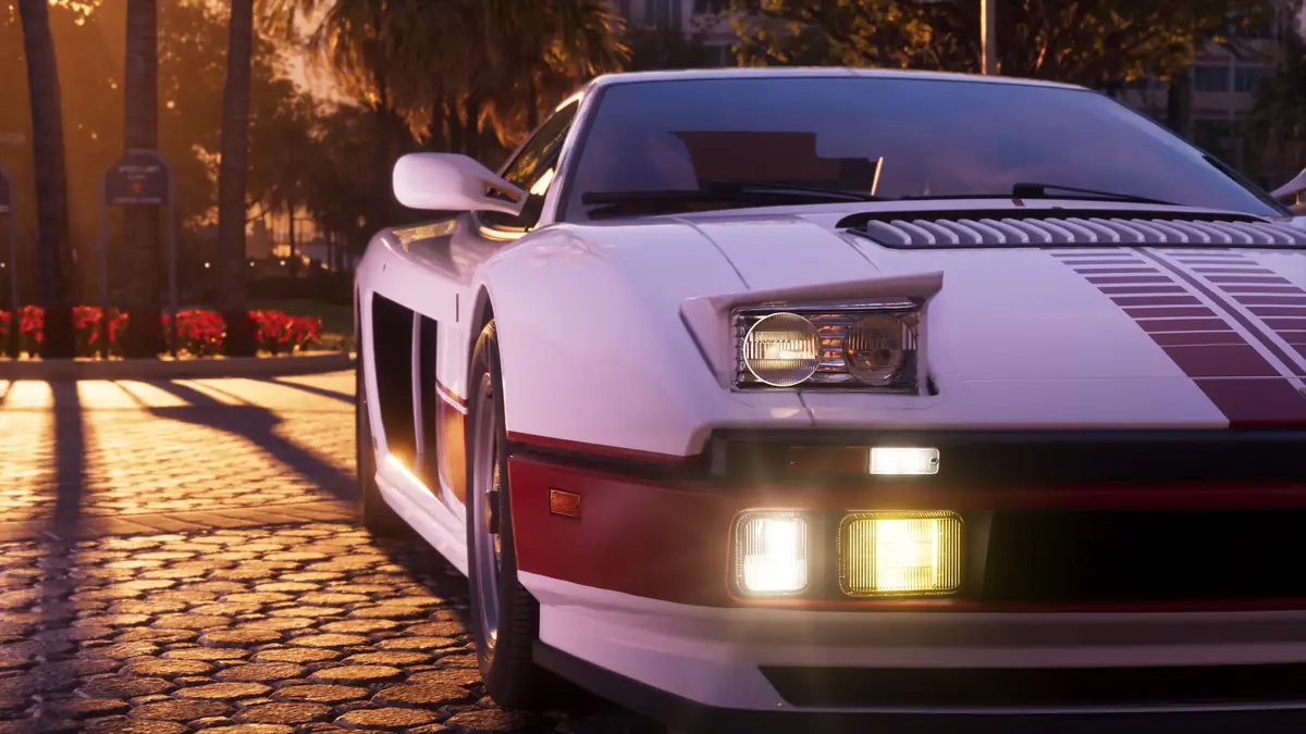 the front of a white sports car with red stripes and lit headlights on a sunny palm lined street in a Rockstar Games image for GTA 6